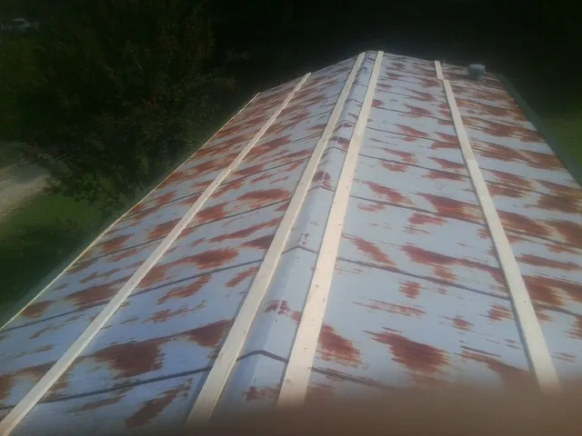 Rusted metal roof panels with new wood purlins before replacement — Storm Damage Roof Repair in Oakville by Roofing Brothers